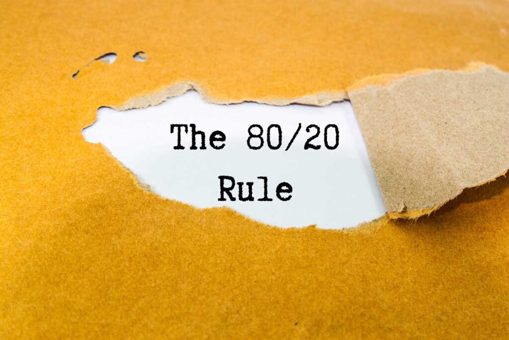 A conceptual image showing paper being torn back to reveal the 80/20 rule